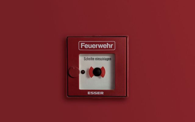 A fire alarm call point on a wall