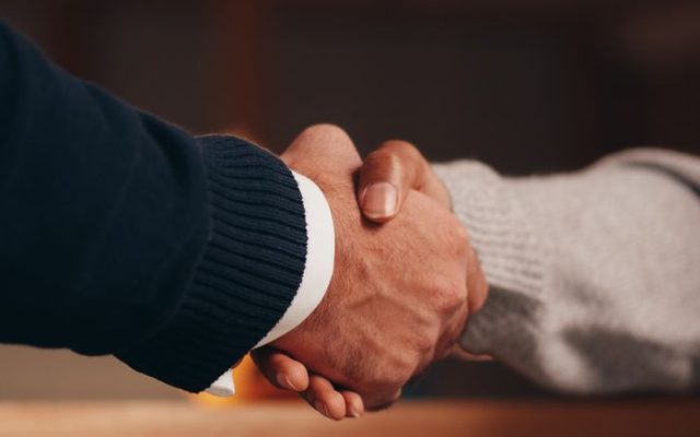 A handshake on completed work